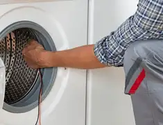 Dryer repair technician diagnosing and servicing a clothes dryer in Newark, NJ