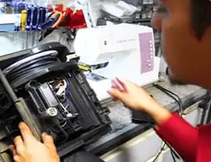 Vacuum repair technician servicing internal components on a workbench in Newark, NJ
