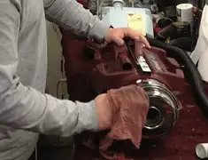 Vacuum repair technician cleaning and servicing a vacuum motor in Newark, NJ