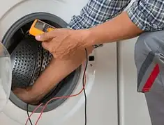 Washing machine repair technician testing a front-load washer with diagnostic tools in Newark, NJ